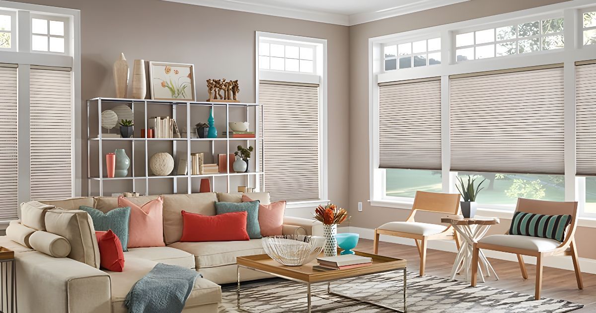 A living room with a couch , chairs , coffee table and blinds.