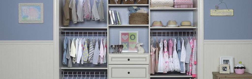 A closet filled with lots of clothes and a drawer.