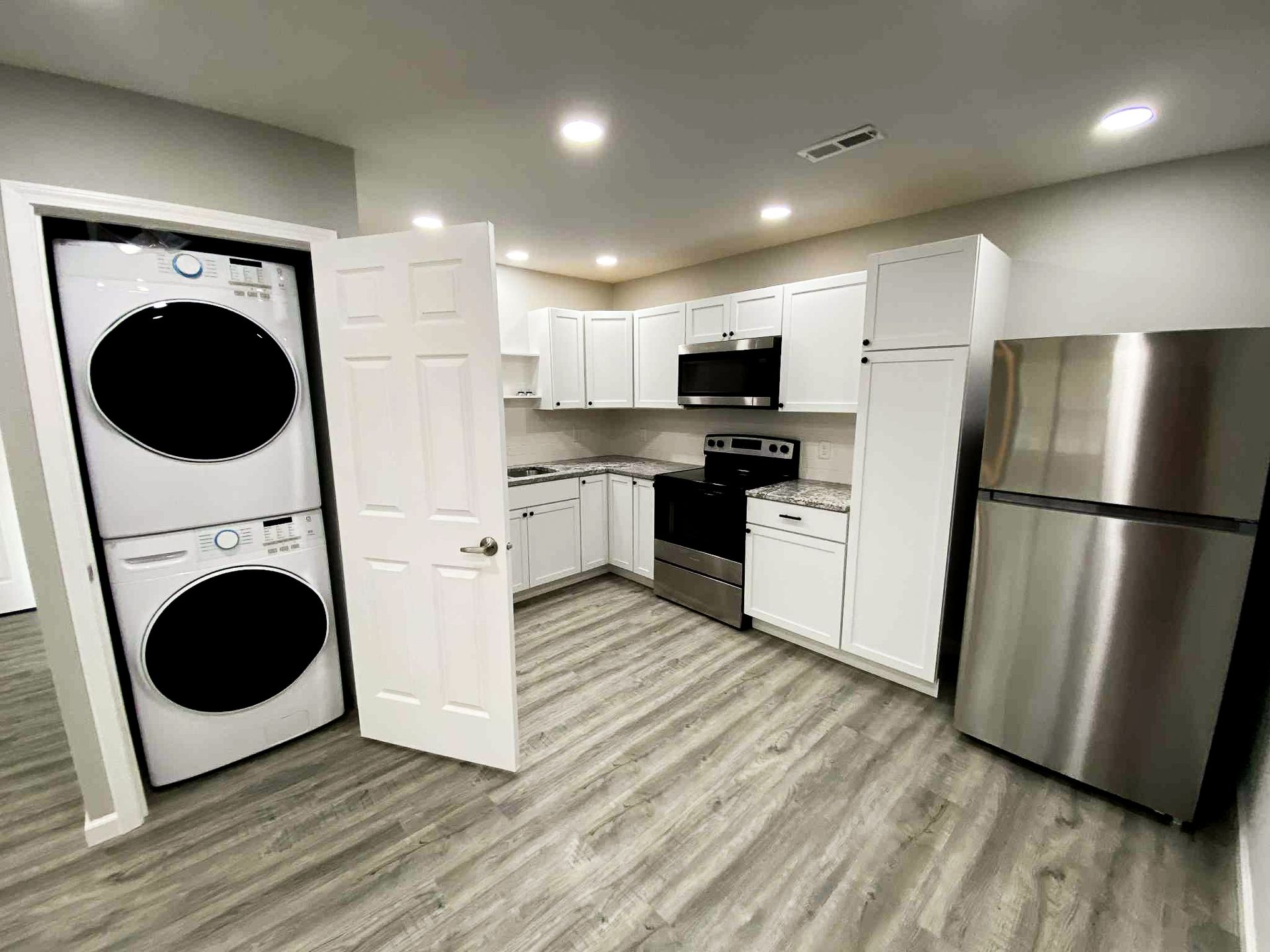 Laptop displaying rent collection app interface; rent payment advertisement.