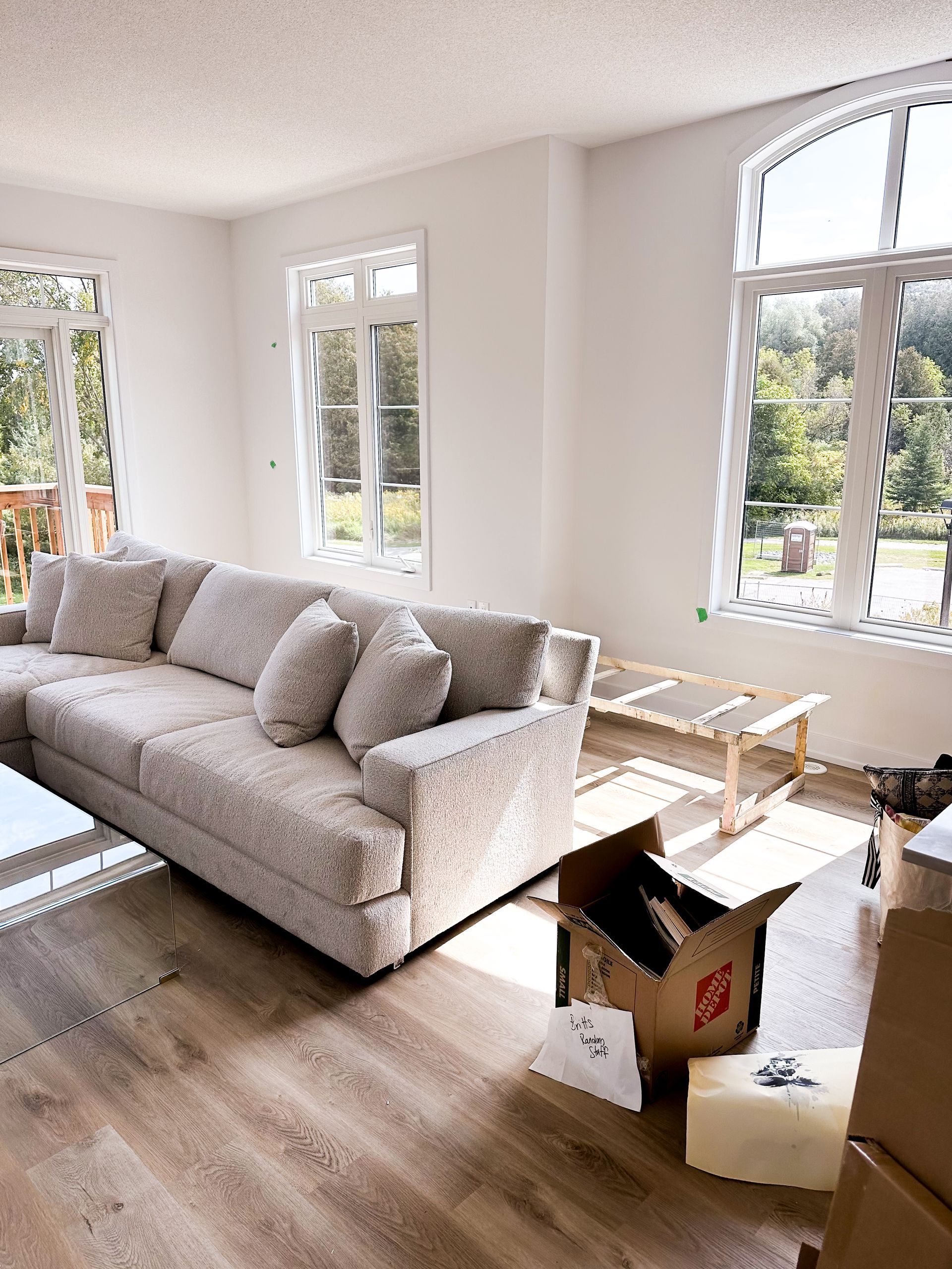 Family and real estate agent viewing a kitchen in a new home. Agent holds paperwork.