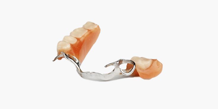 A close up of a partial denture on a white background.