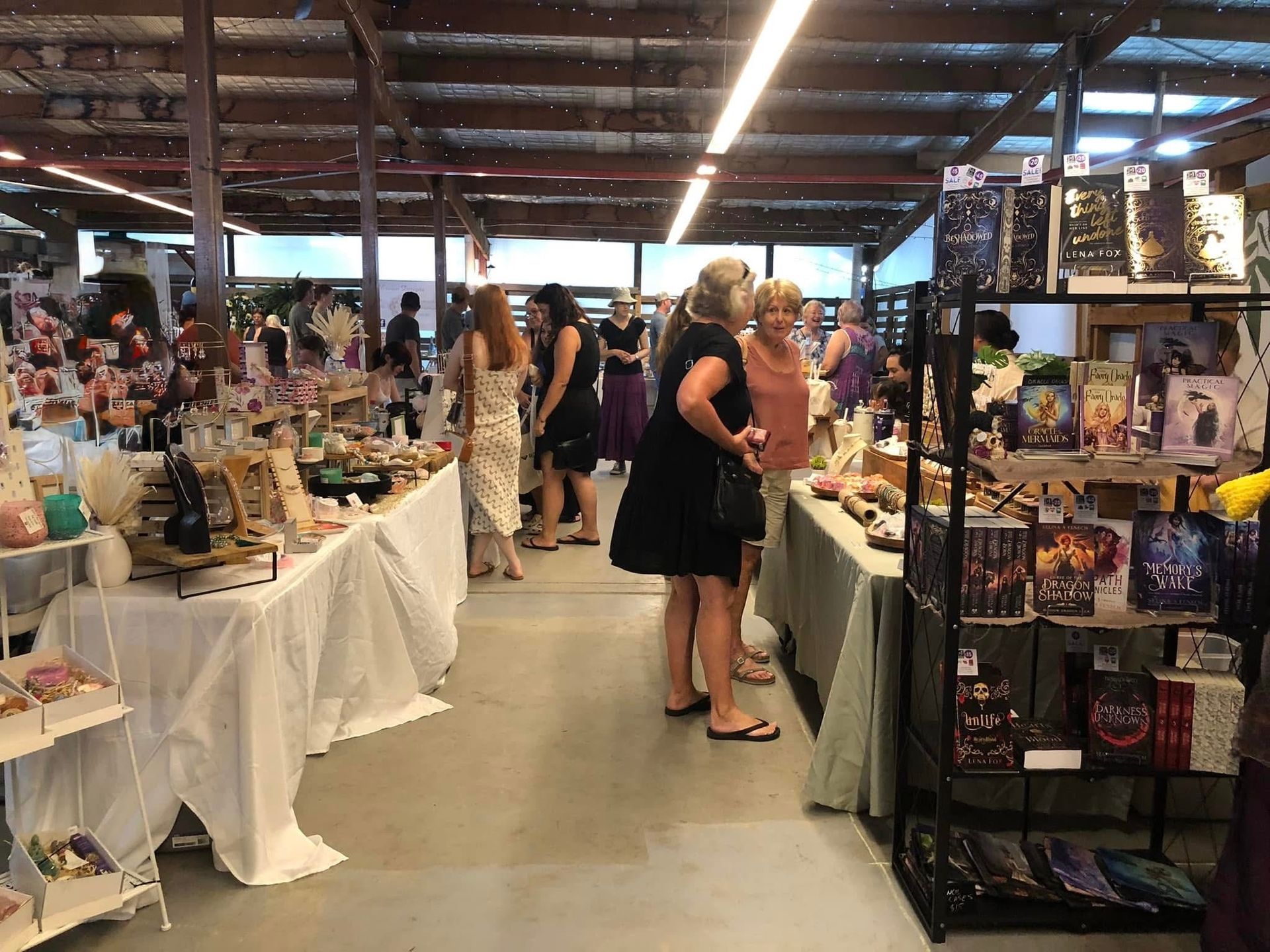 Indoor market with vendors and shoppers browsing displays of various goods — Rustique on the Coast In Ourimbah, NSW