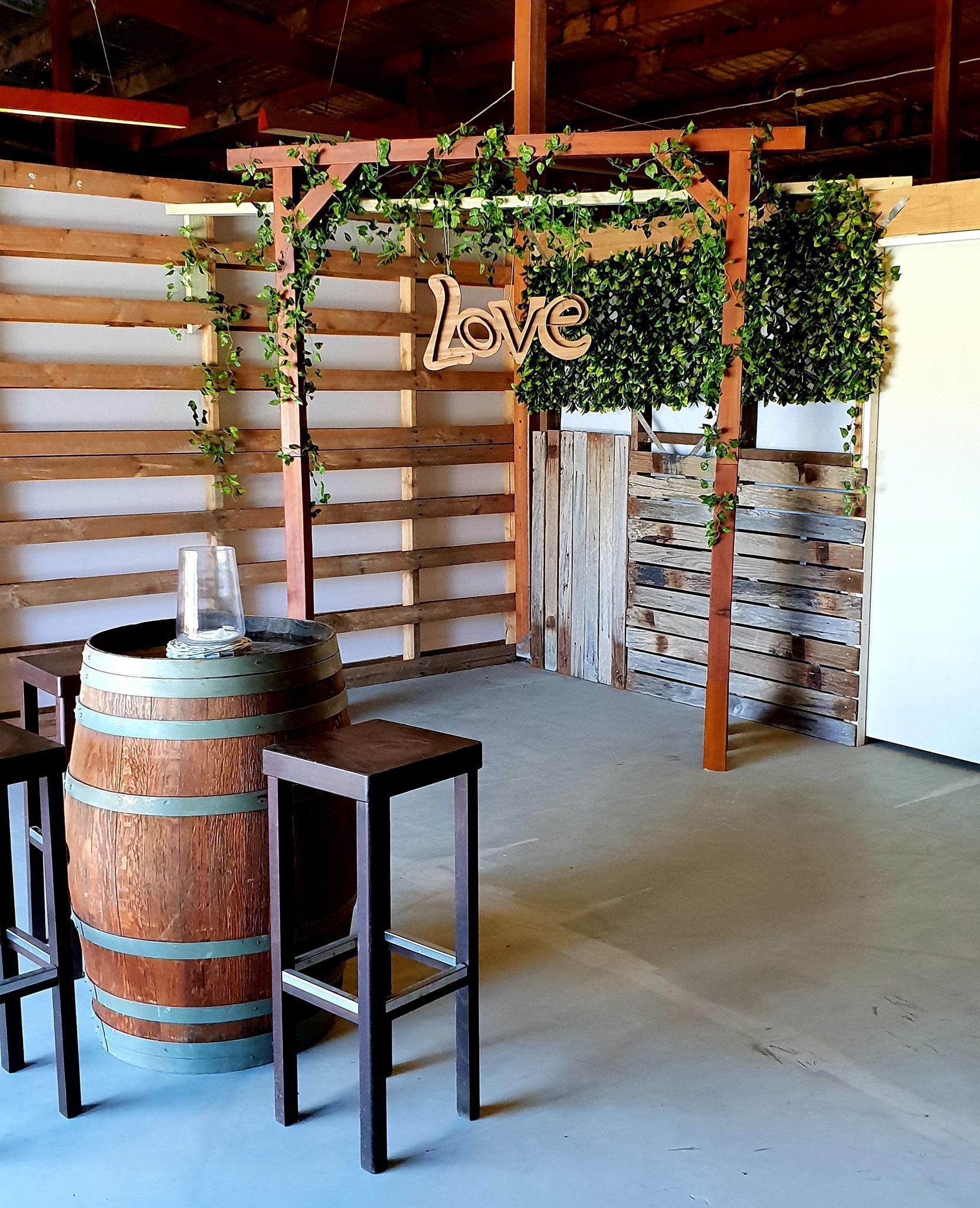 Rustic Bar Setup With Wooden Barrel, Stools, and Slat Wall — Rustique on the Coast In Ourimbah, NSW