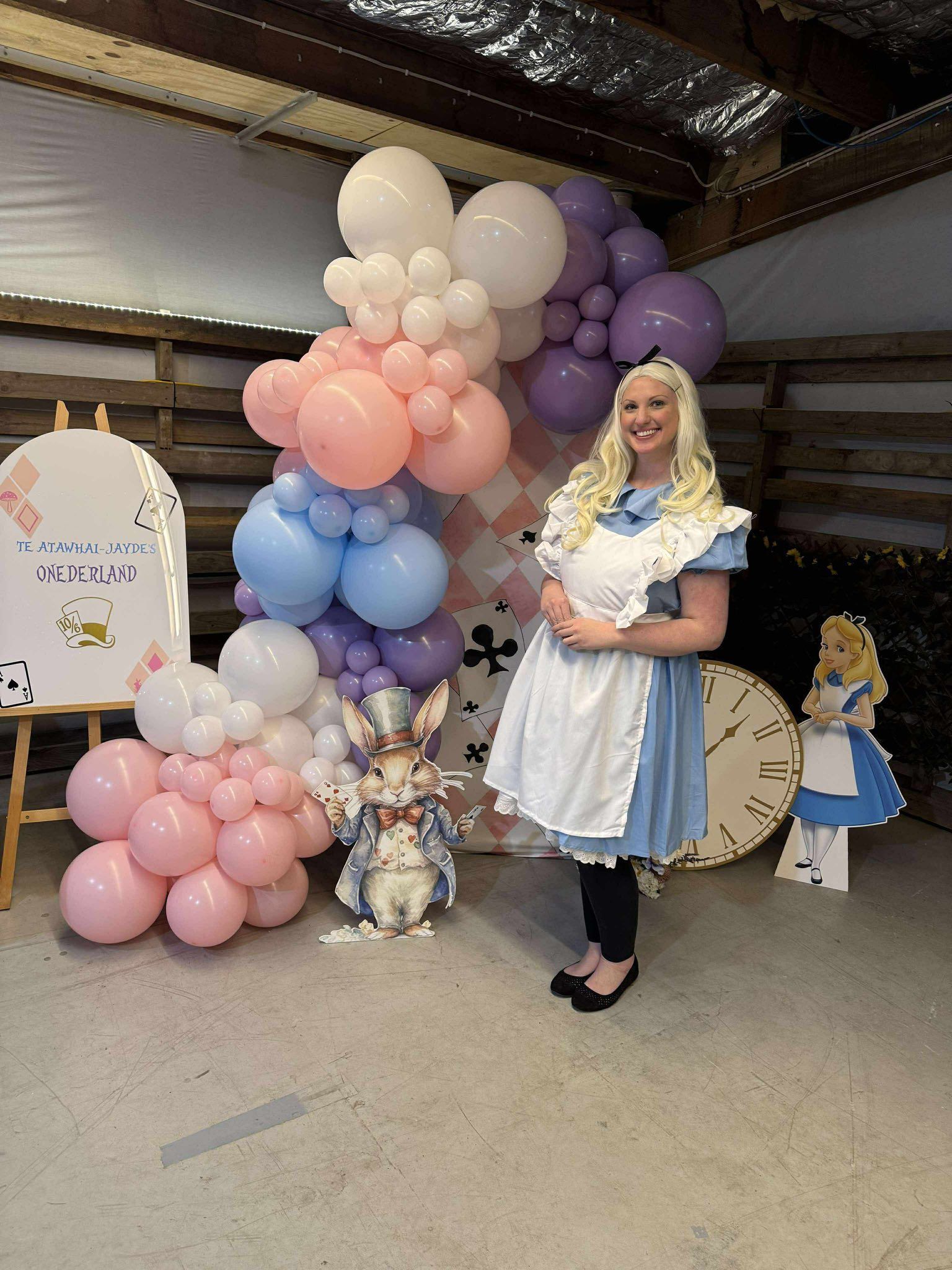 Woman in Alice Costume Poses With Balloon Arch and Decor — Rustique on the Coast In Ourimbah, NSW