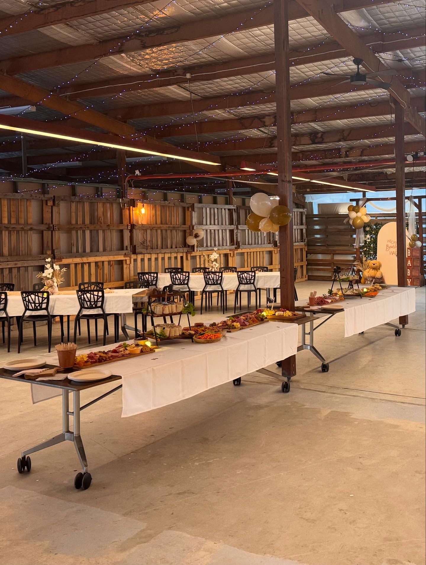 Long Tables Set With Food for an Event in a Rustic, Open-air Barn — Rustique on the Coast In Ourimbah, NSW