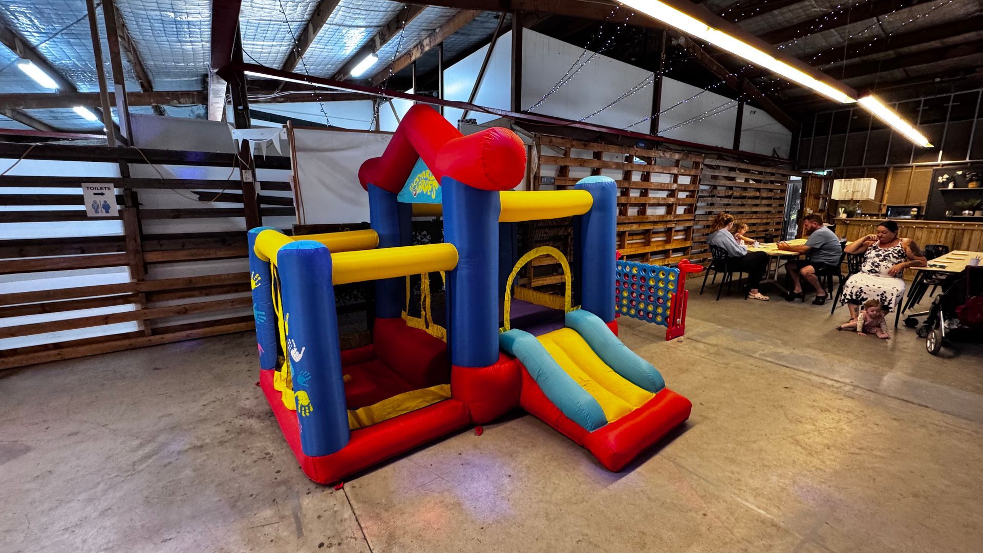 Bouncy castle inside a building with people at tables — Rustique on the Coast In Ourimbah, NSW