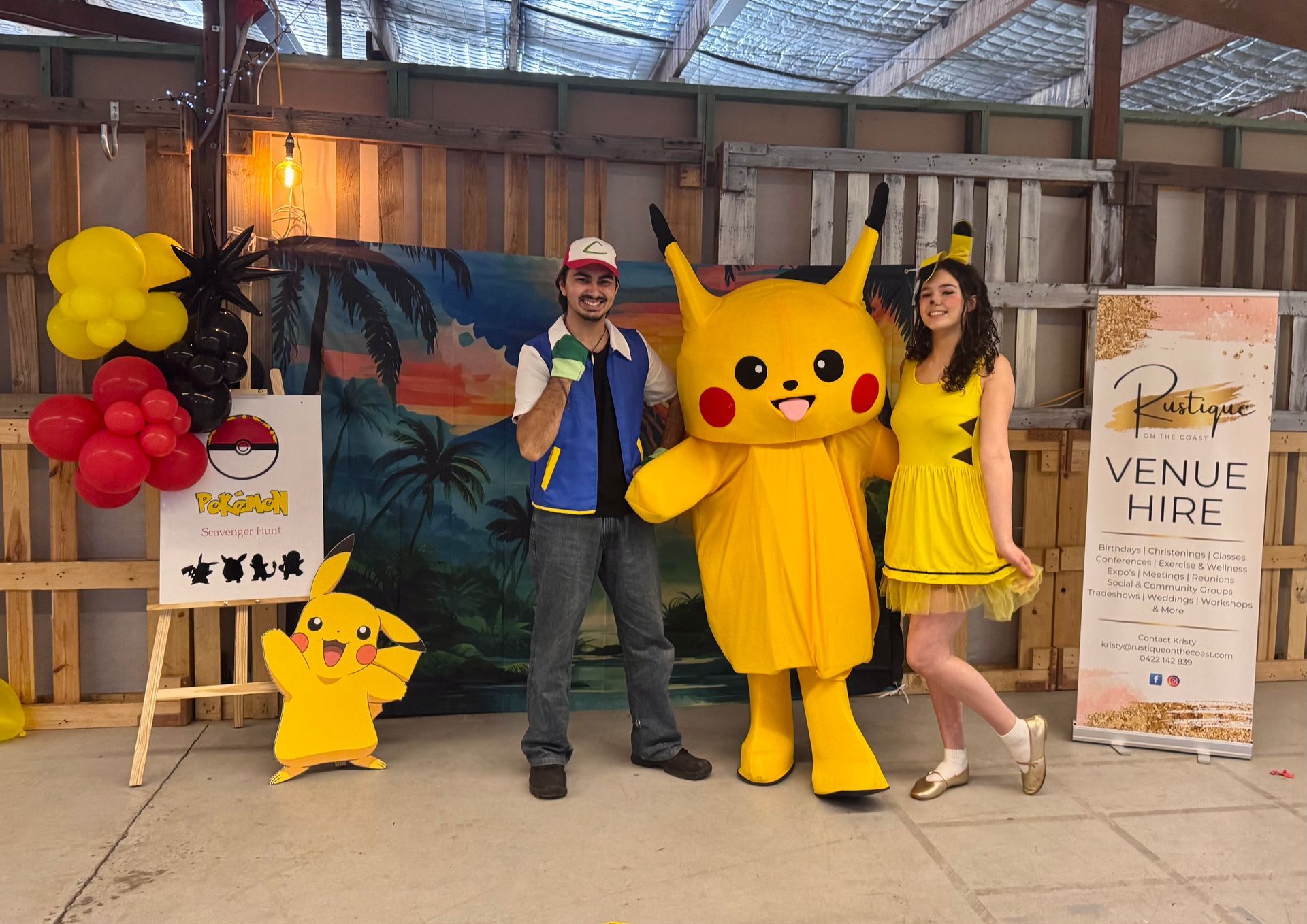 A Person Dressed as a Pokémon Trainer, Pikachu mascot, and a Woman in a Pikachu — Rustique on the Coast In Ourimbah, NSW