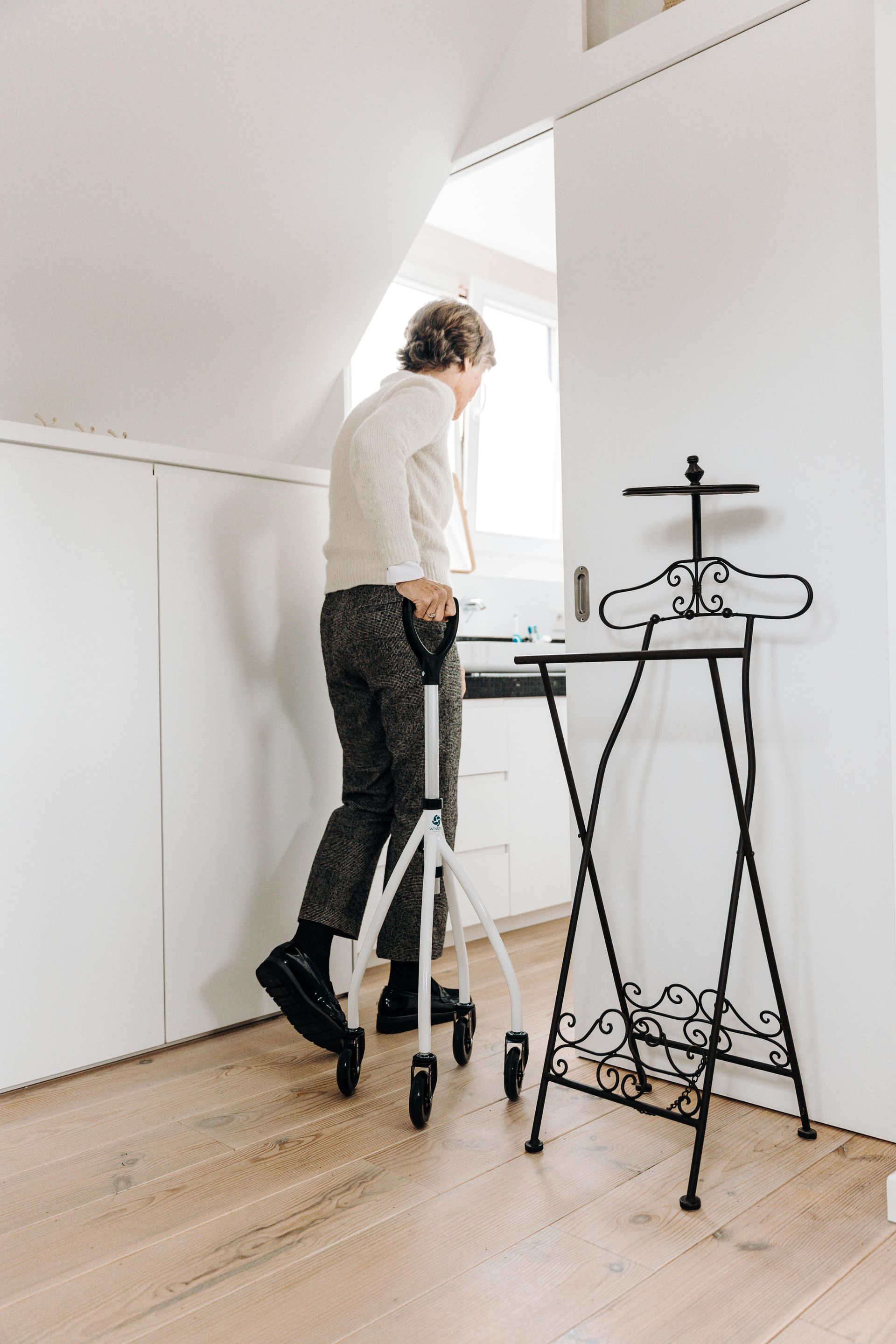 A man is standing on a tripod in a room.