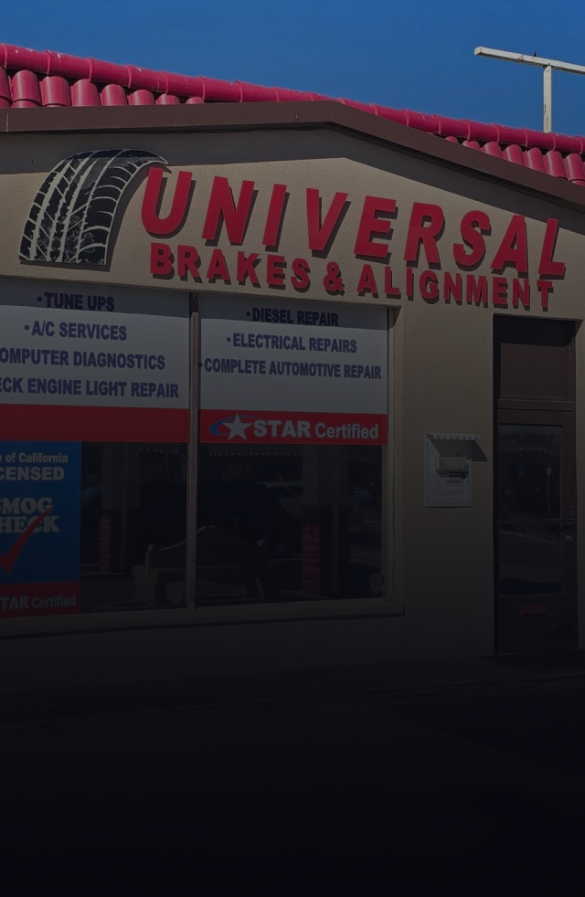 Universal Brakes & Alignment shop exterior with red lettering, tire graphic, and services listed. | Universal Brakes & Alignment