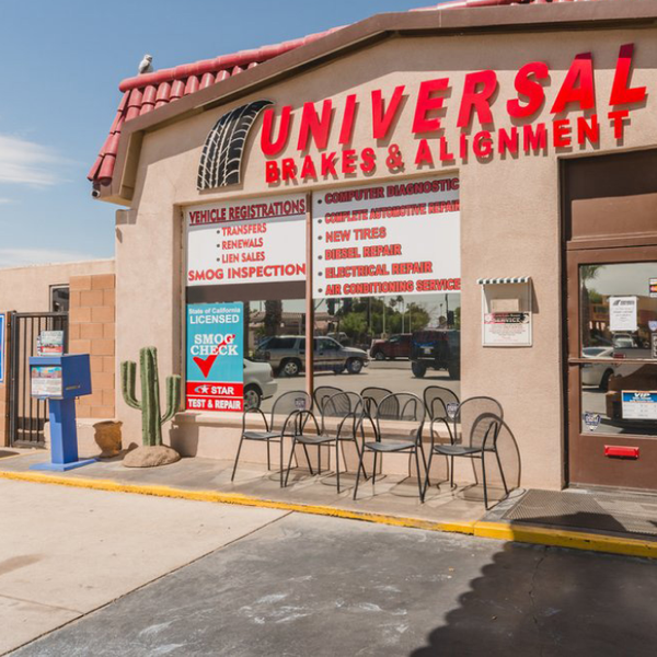 Universal Brakes & Alignment shop exterior. Red signage, tan building, chairs outside, cactus, blue mailbox. | Universal Brakes & Alignment