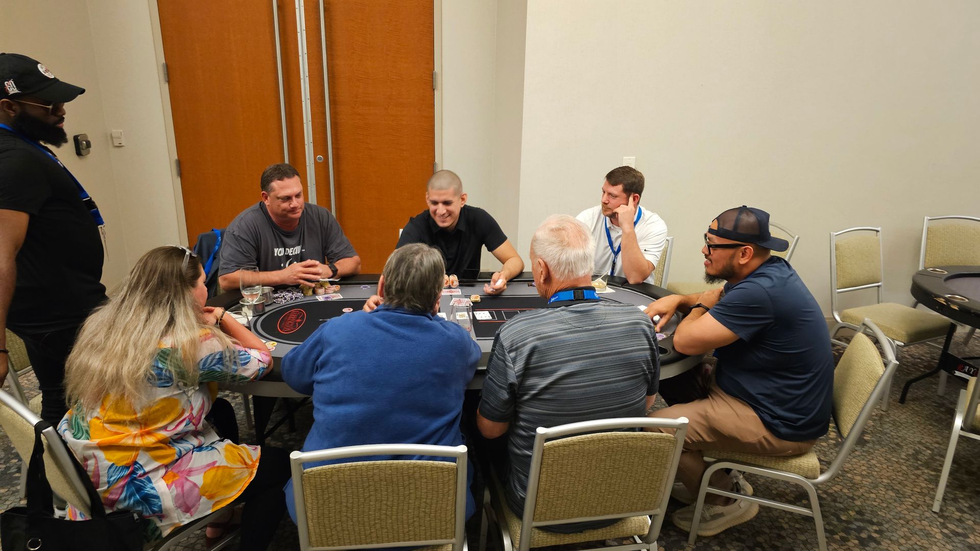 A group of people are sitting around a table playing poker.