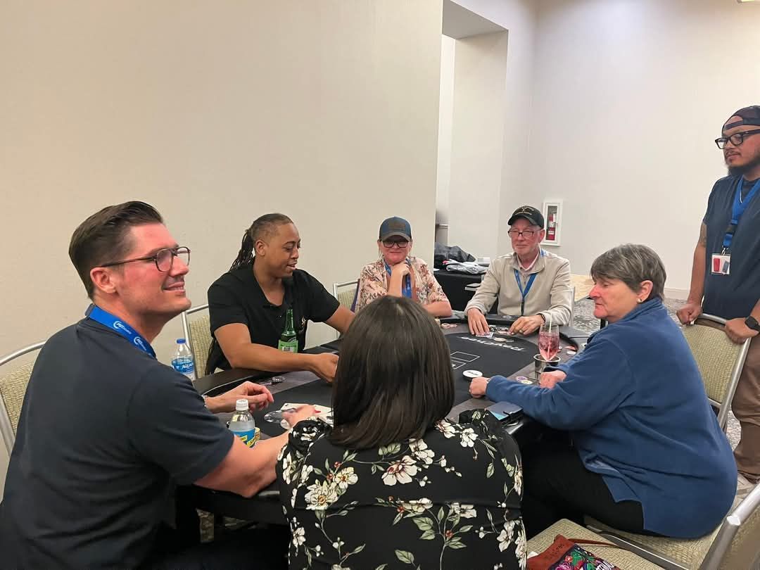 A group of people are sitting around a table in a room.