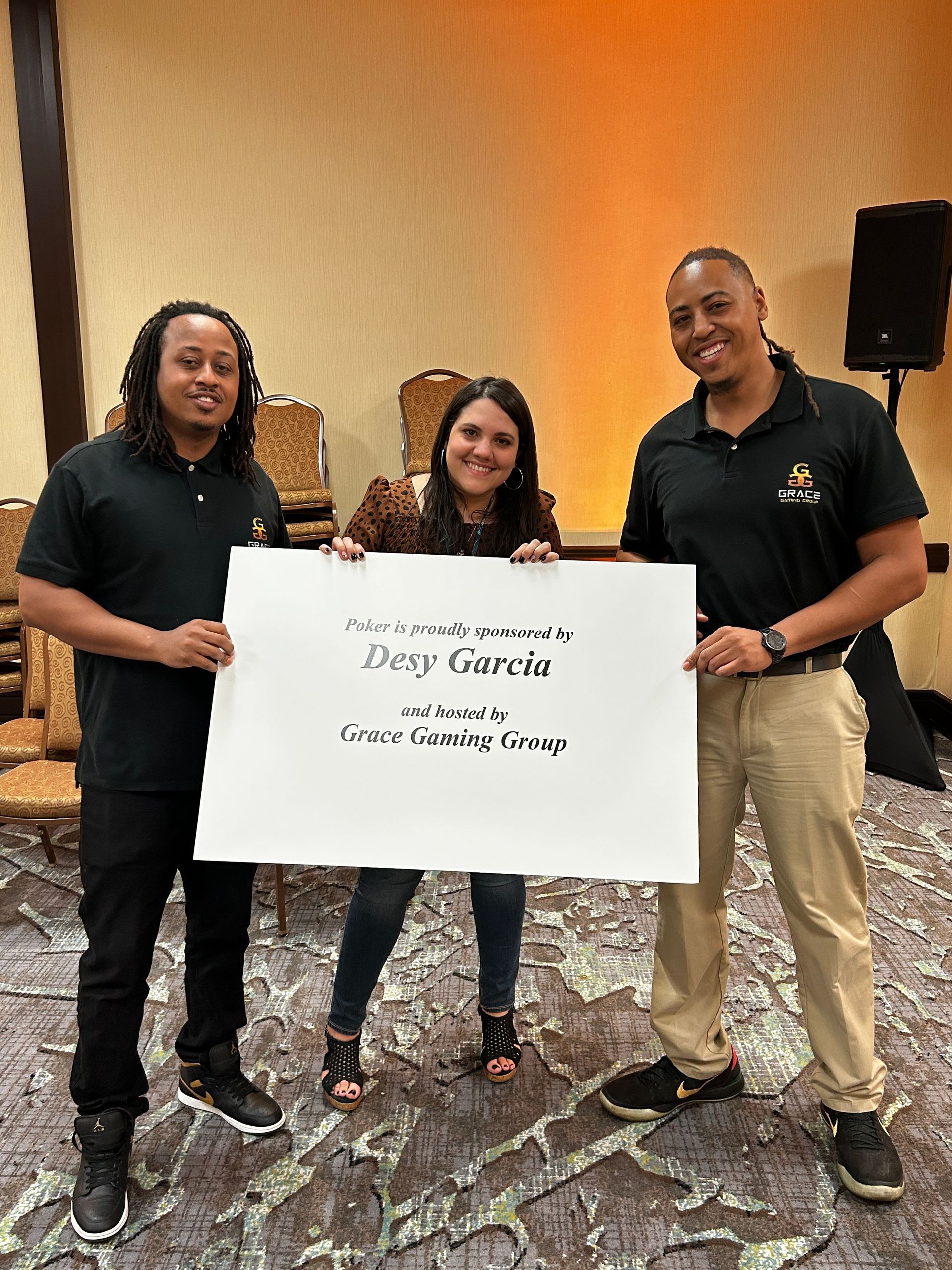 Three people holding a sign that says deep garcia