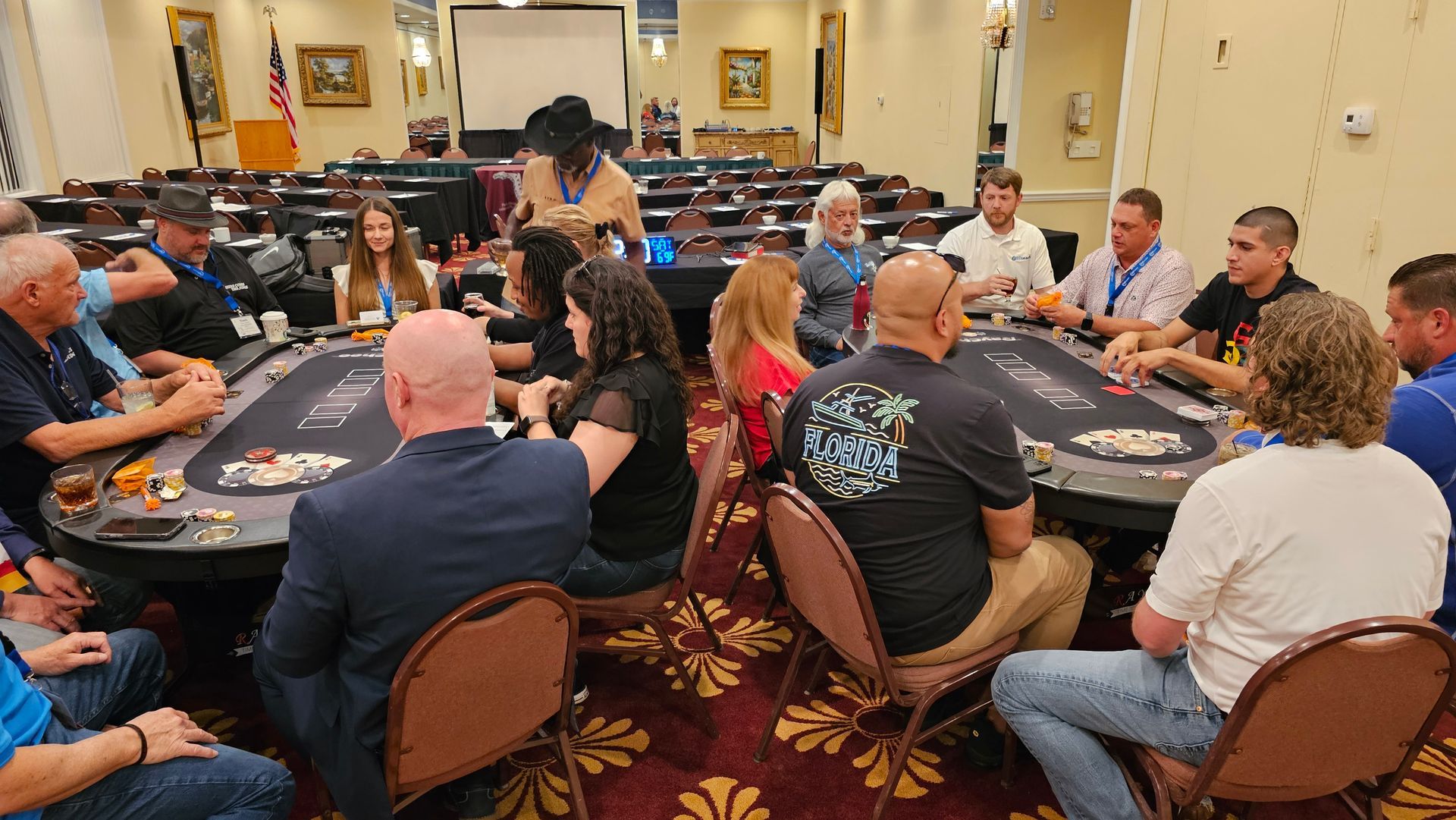 A group of people are sitting around a table playing poker.
