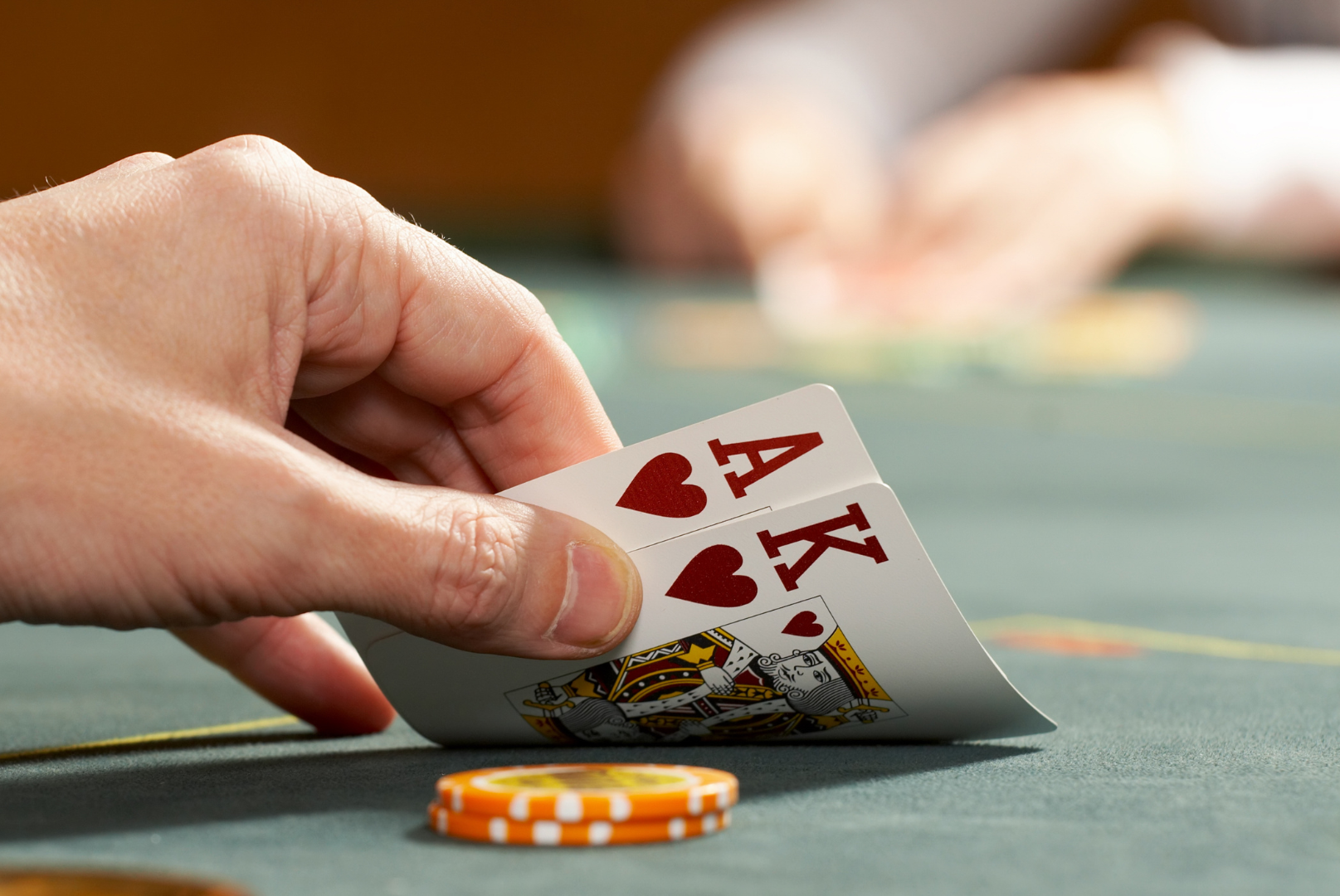 A person is holding a pair of aces in their hand