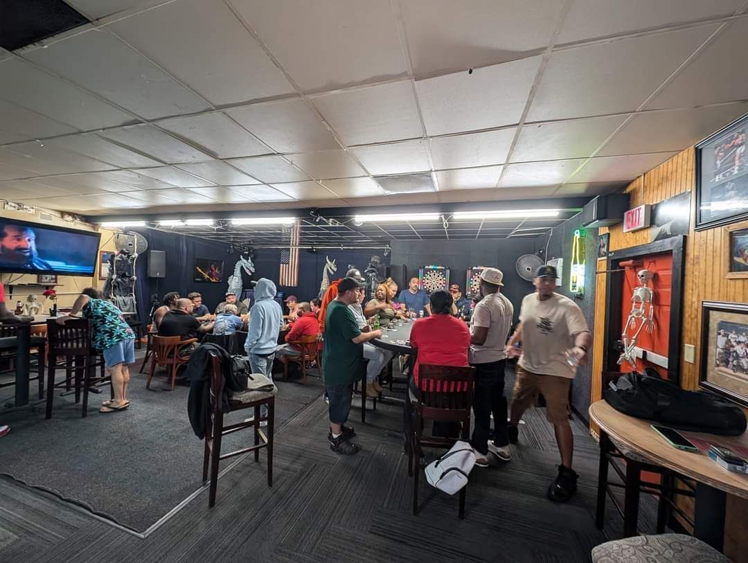 A group of people are sitting at tables in a restaurant.