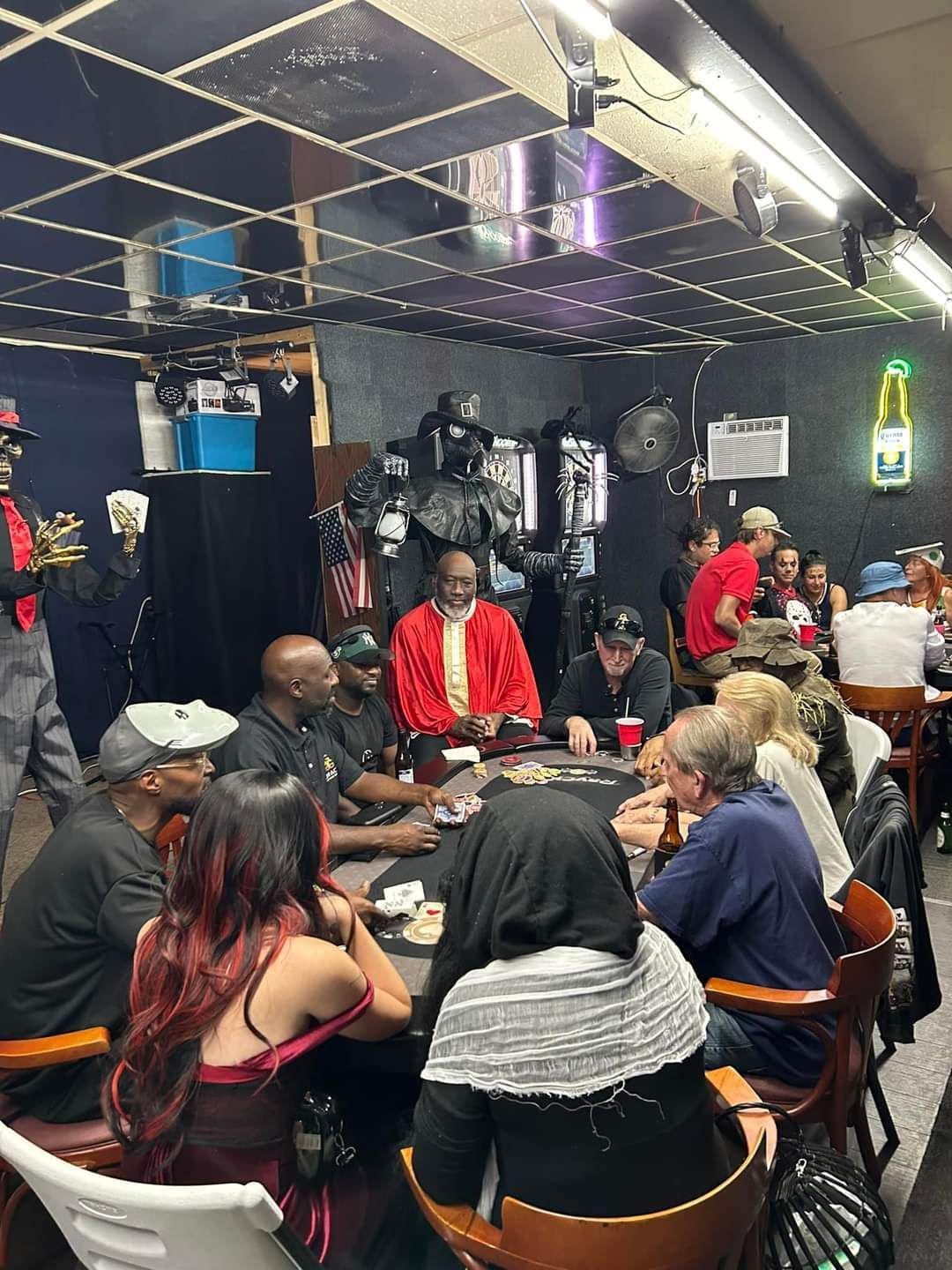A group of people are sitting around a table in a restaurant.