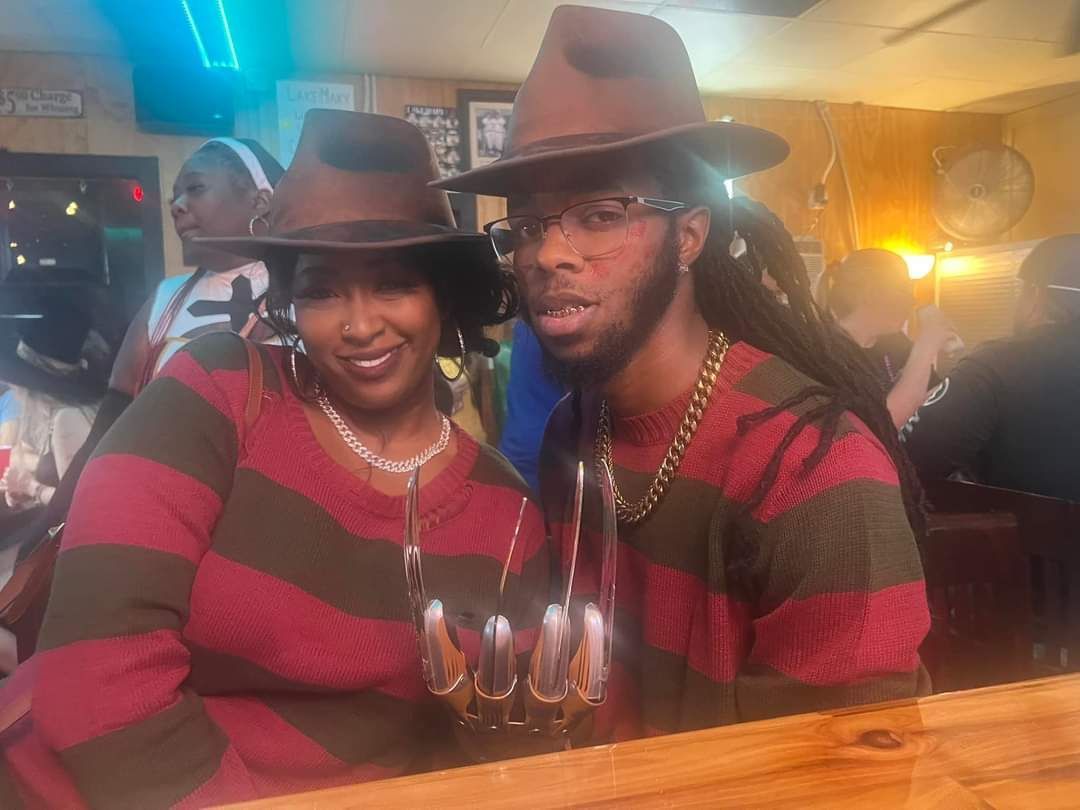 A man and a woman are sitting next to each other in a bar.