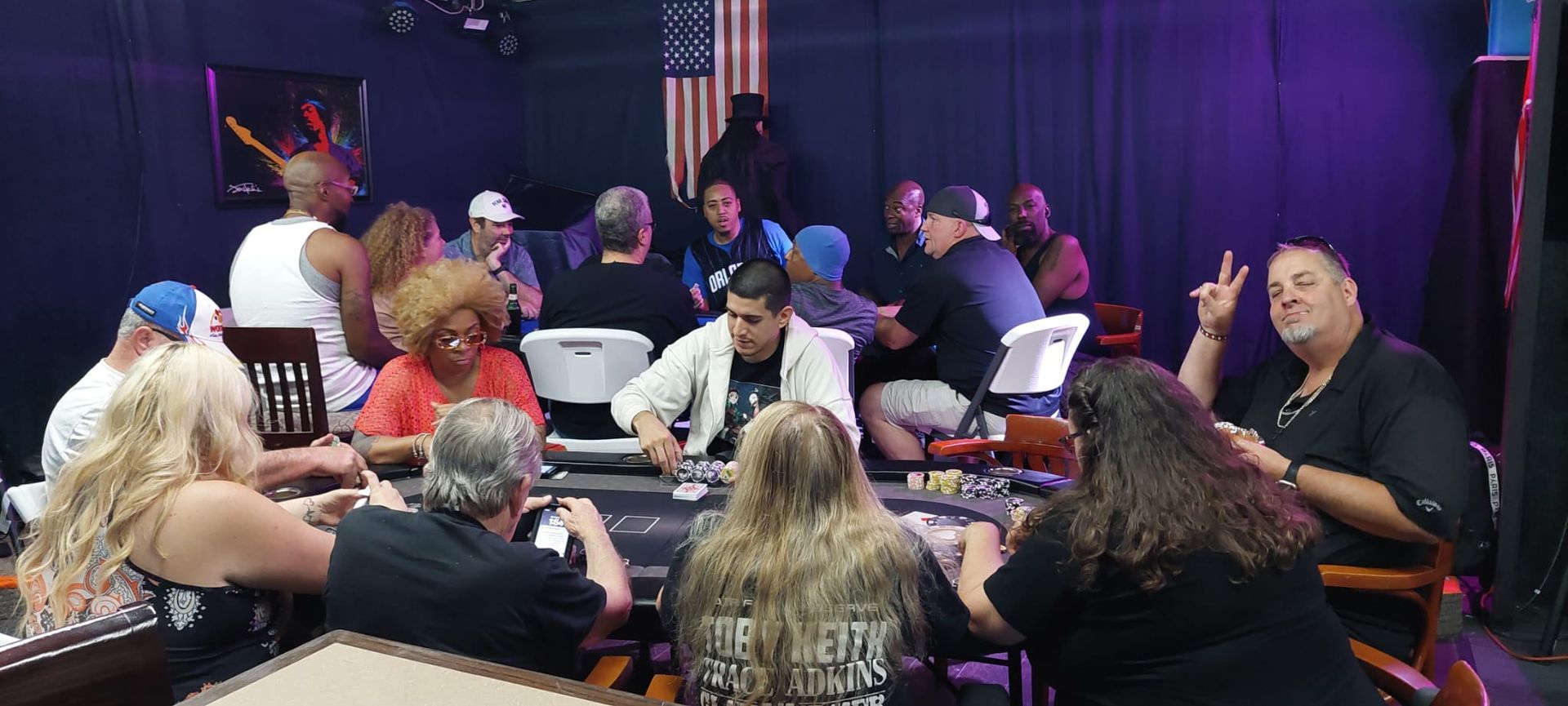 A group of people are sitting at a table playing poker.