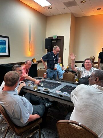 A group of men are sitting around a table playing poker.