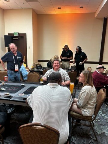 A group of people are sitting around a table in a room.