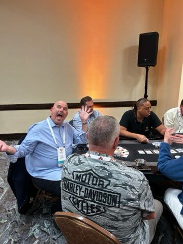 A group of men are sitting at a table playing poker.