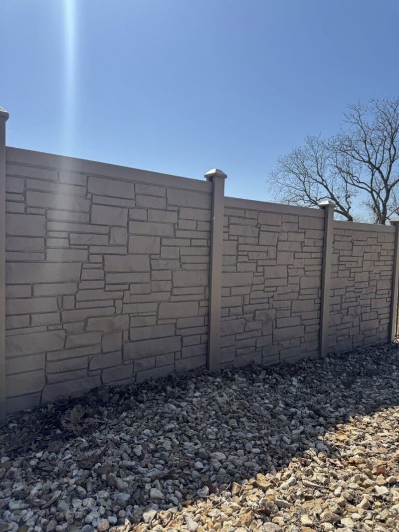 A concrete fence with a blue sky in the background.