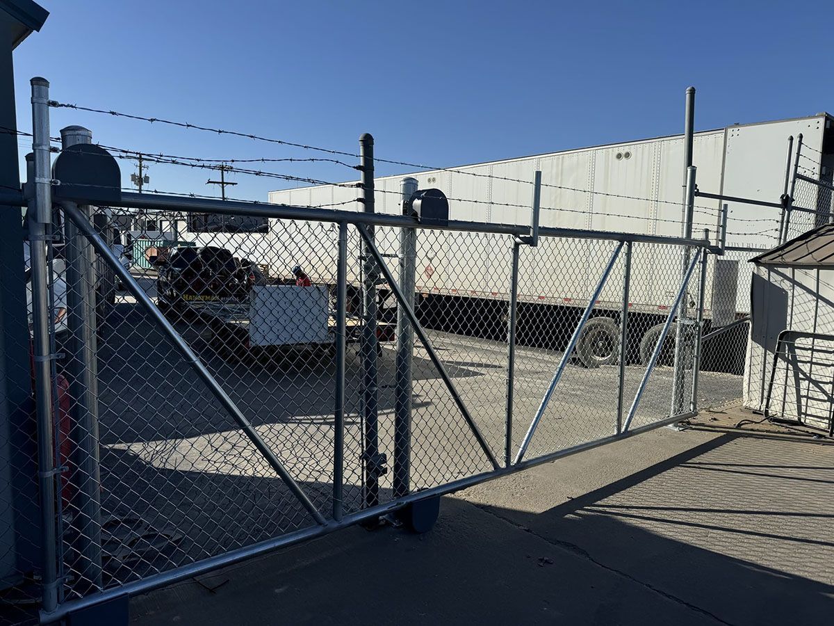 A chain link fence with a truck in the background