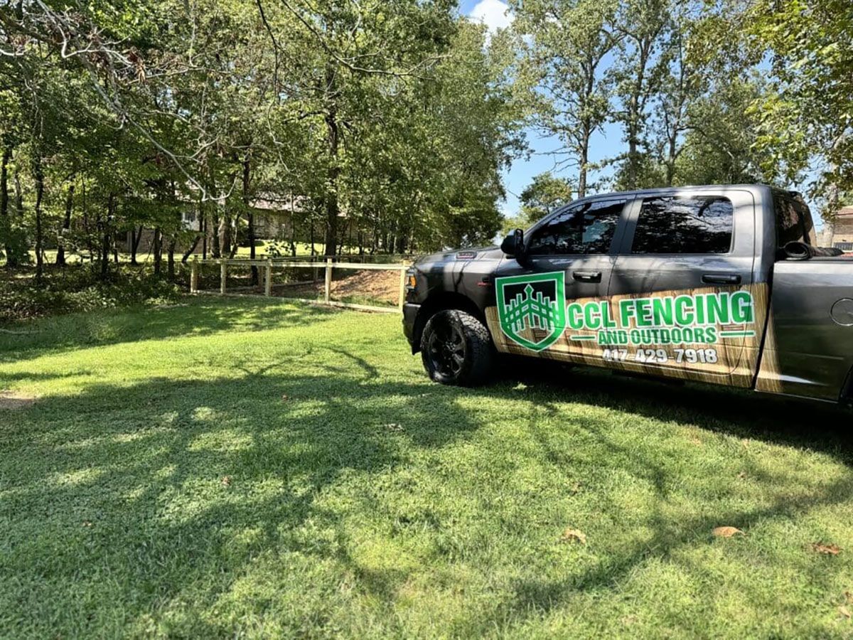 A truck is parked in a lush green field.