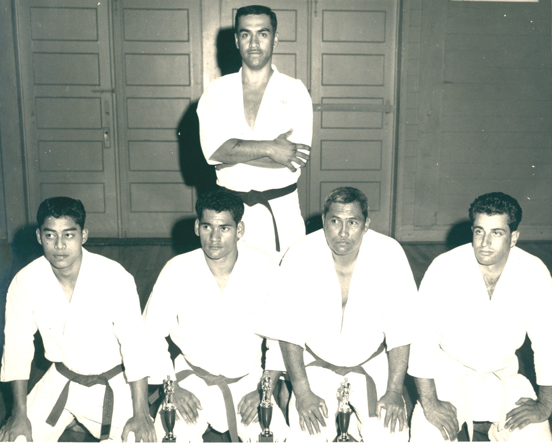 A group of karate practitioners pose for a photo.