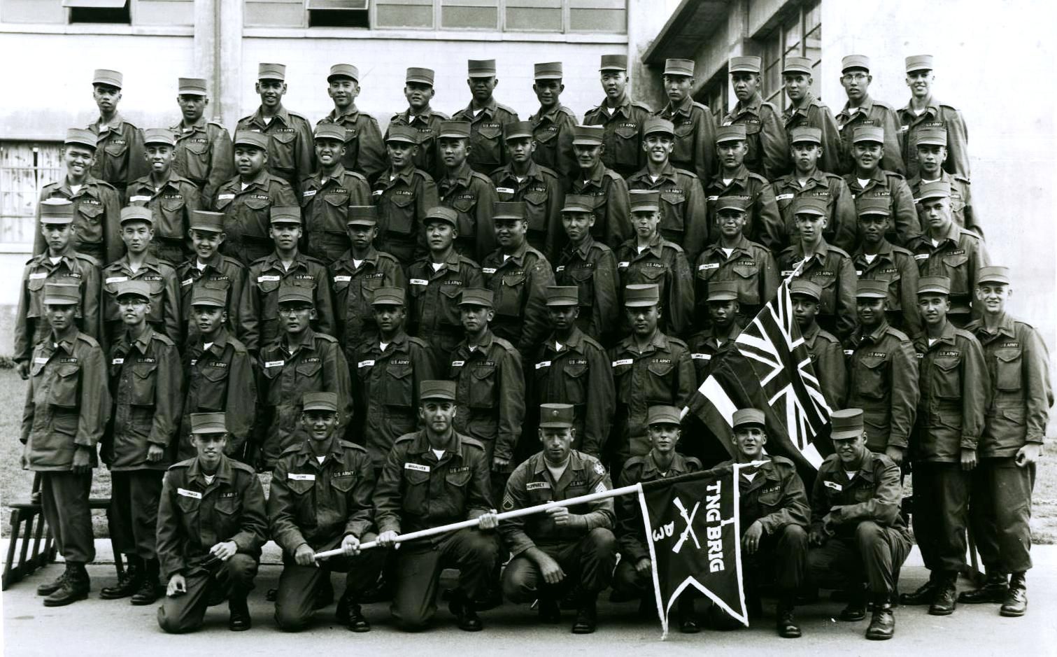 Group of uniformed soldiers, likely a military unit, posing for a photograph outdoors.