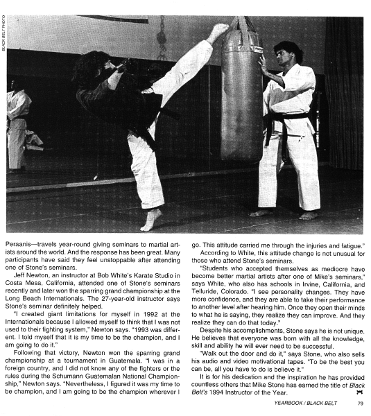 Two men in a karate studio; one kicking and the other in a stance. 