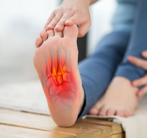 A close up of a person 's foot with a red spot on it.