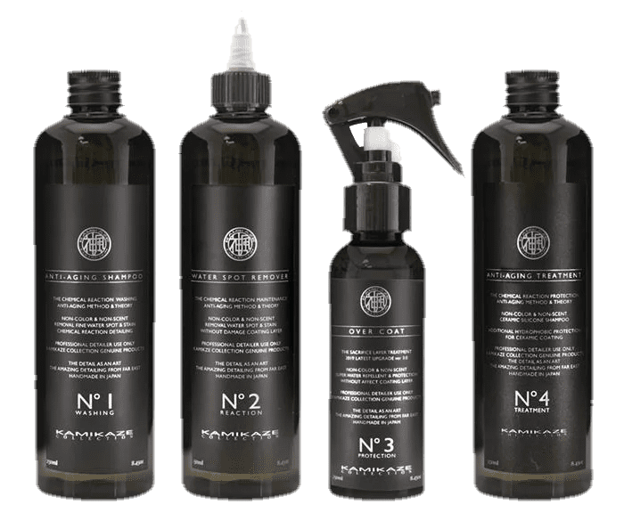 Four black bottles of hair care products with white labels.