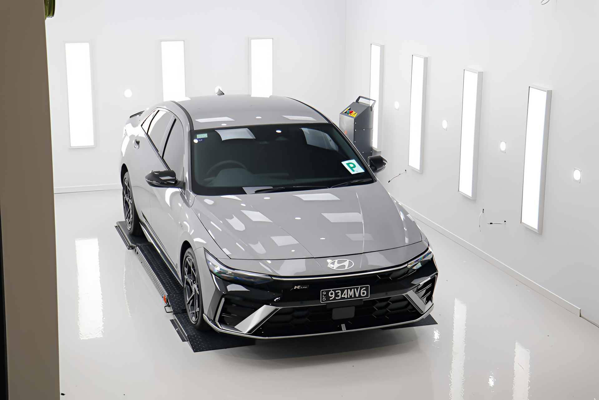 Olive green lifted Ford F-350 truck with black wheels, parked in front of a building.