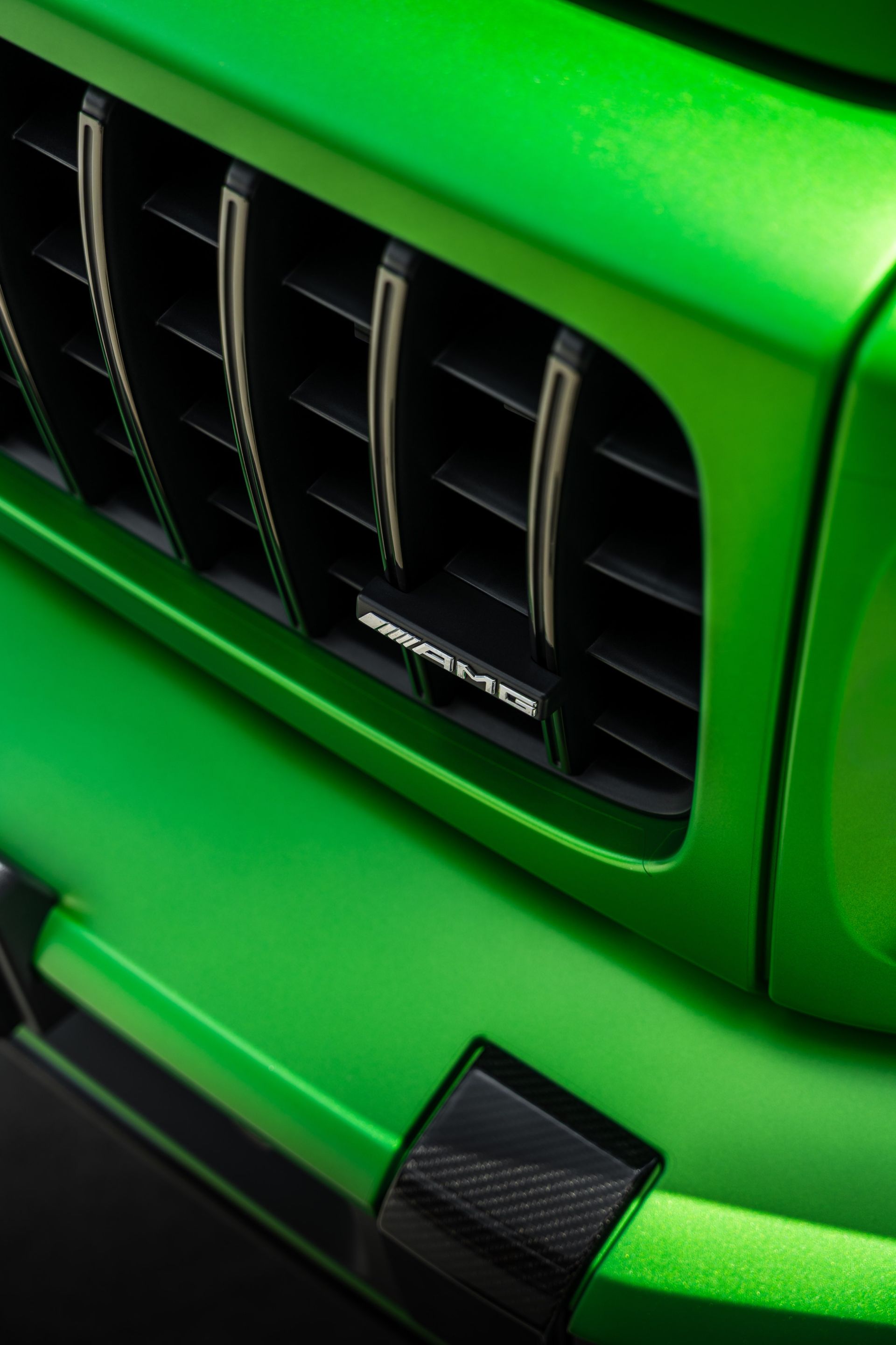 Bright green Mercedes-Benz G-Wagon SUV in a white studio setting with bright lights.