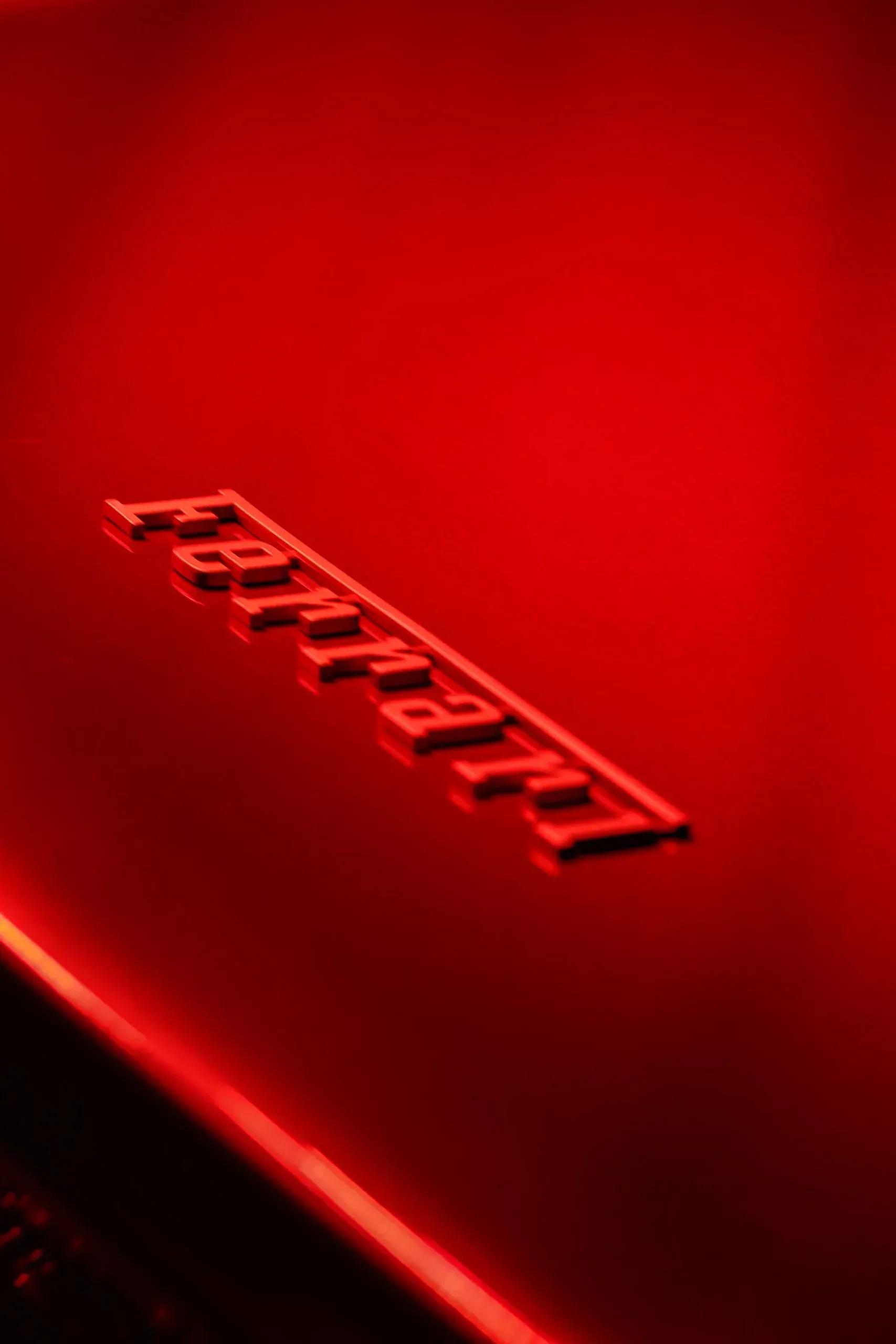 Red Ferrari car with the embossed brand name.