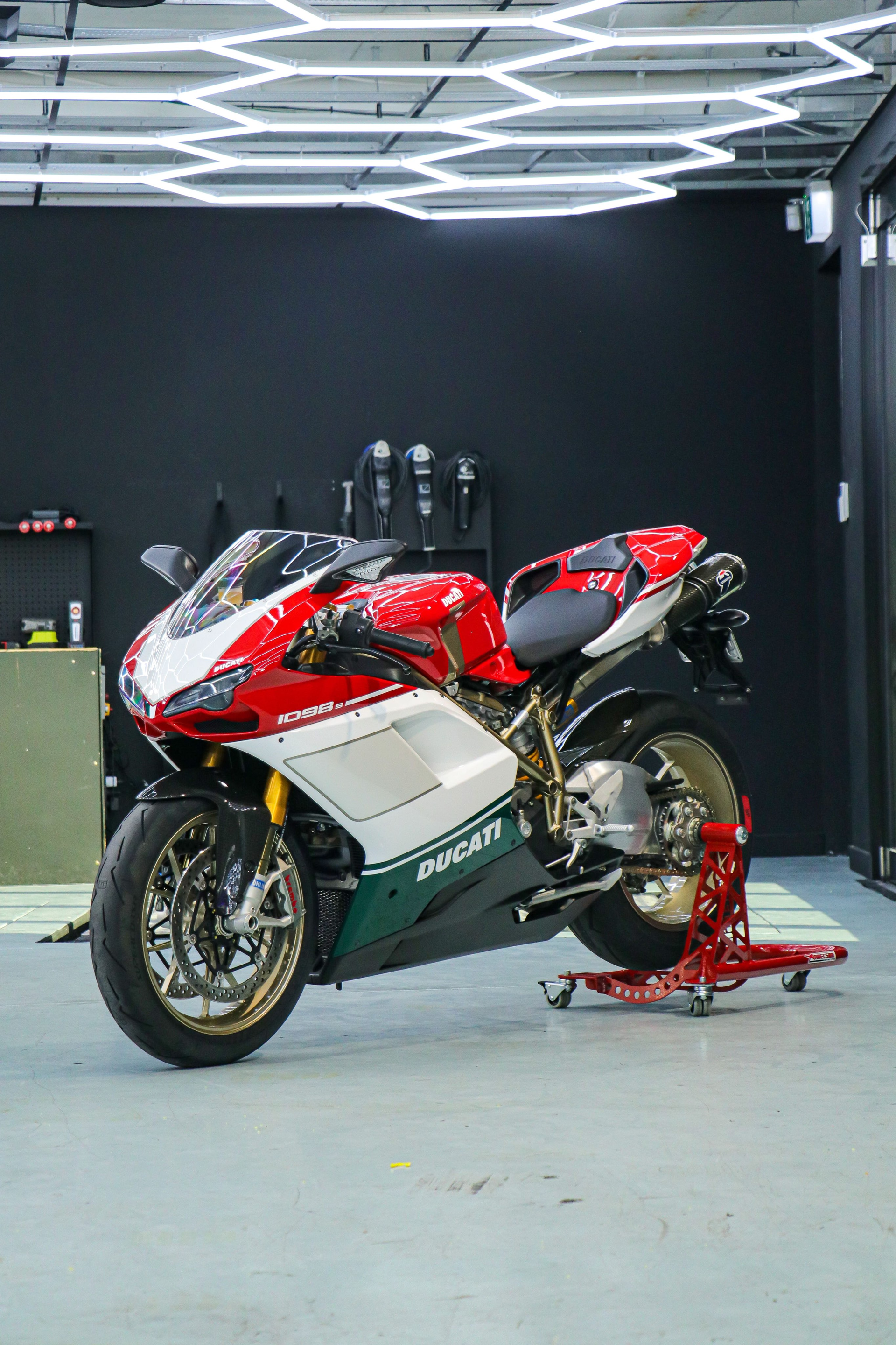 Interior view of a red and black sports car with a steering wheel and dashboard.