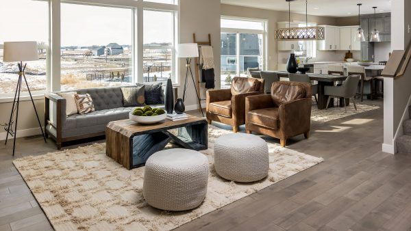 Living room with gray sofa, leather chairs, and wooden coffee table.