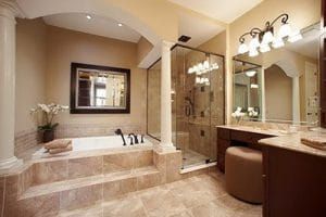 A bathroom with a tub , shower , mirror and vanity.