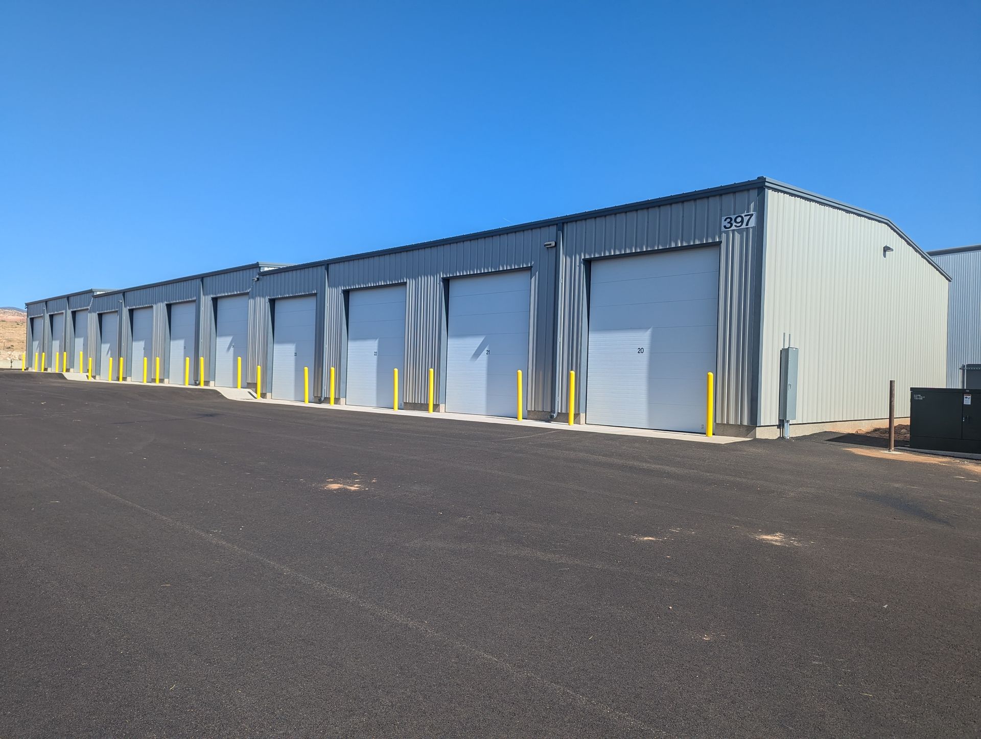 A row of garages with a blue sky in the background