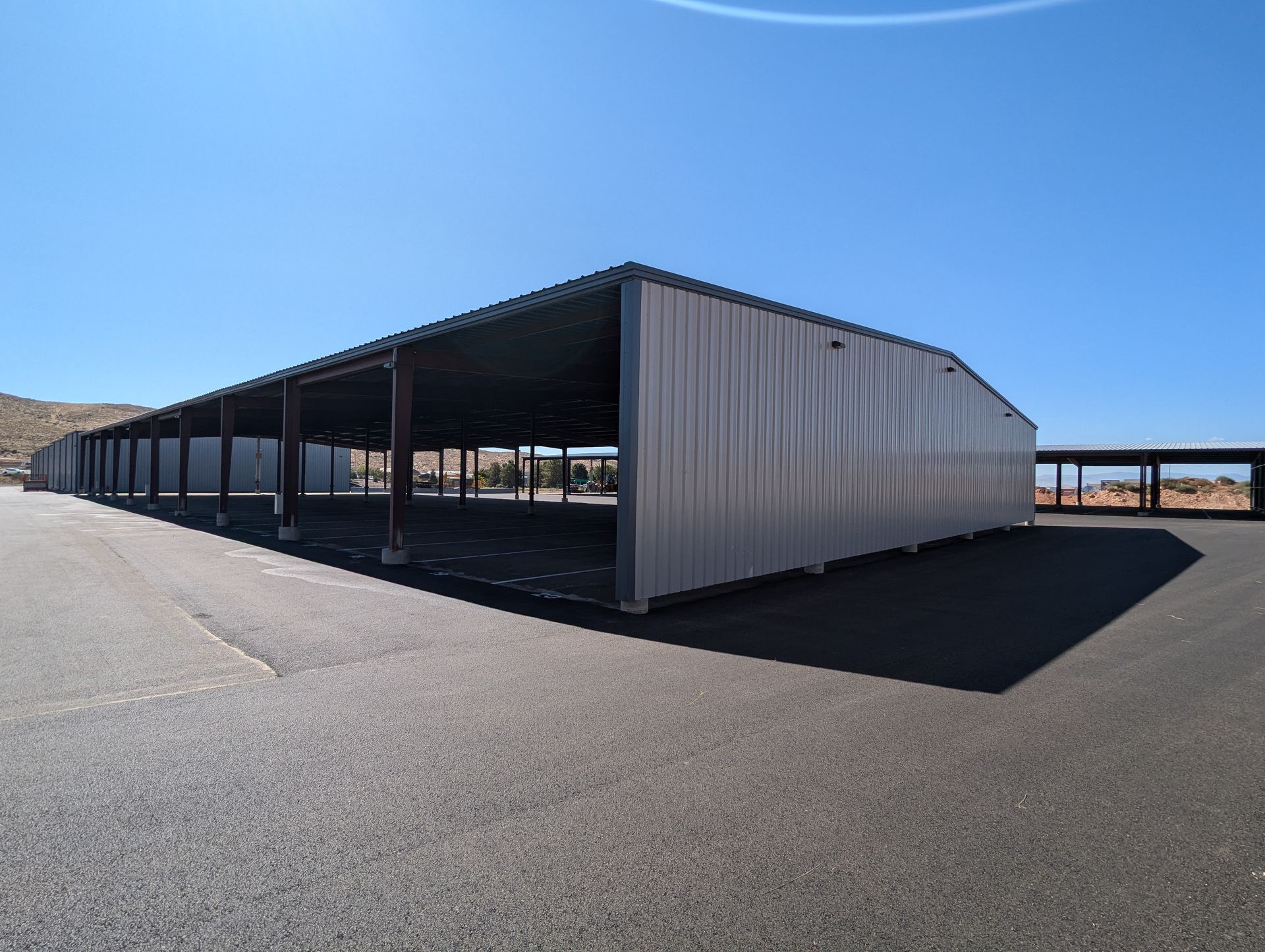 A large metal building with a blue sky in the background