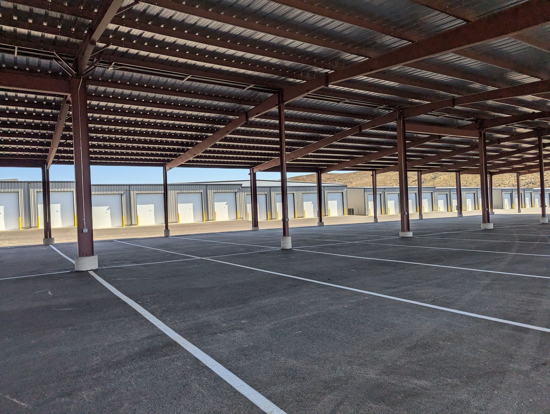 An empty parking lot with a wooden roof