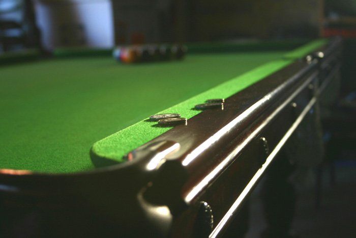 Coins on Pool Table — Greenville, MI — Billiard Recovery Service
