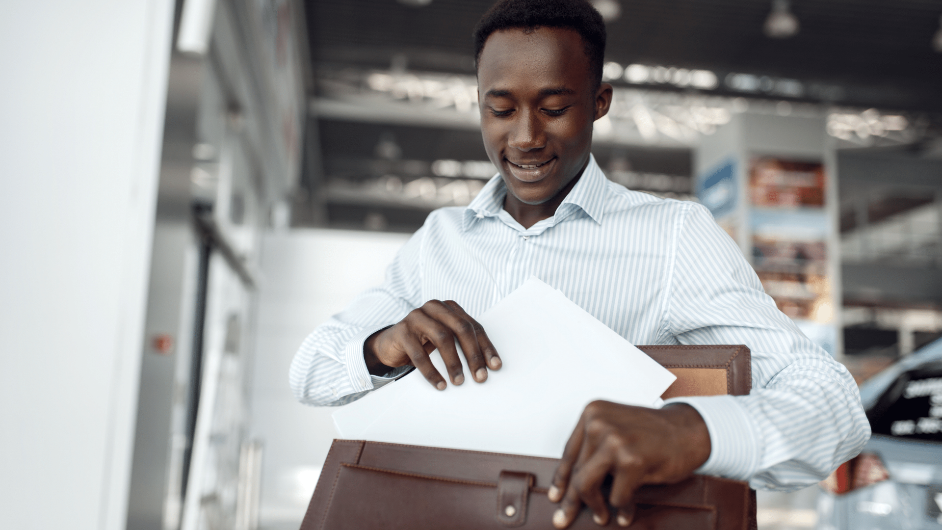 A man is holding a briefcase with a piece of paper in it.