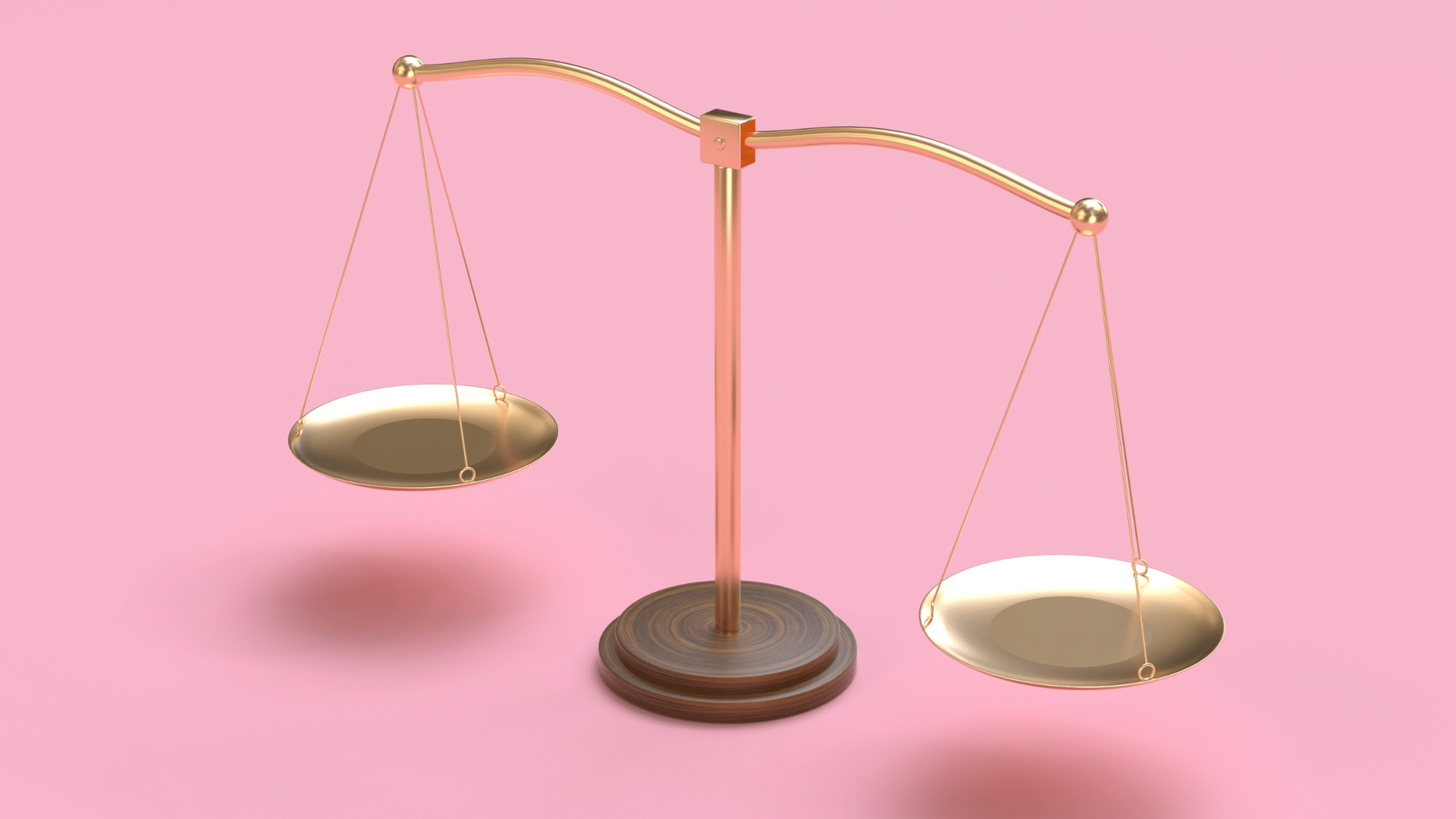 A scale with two plates on a pink background.