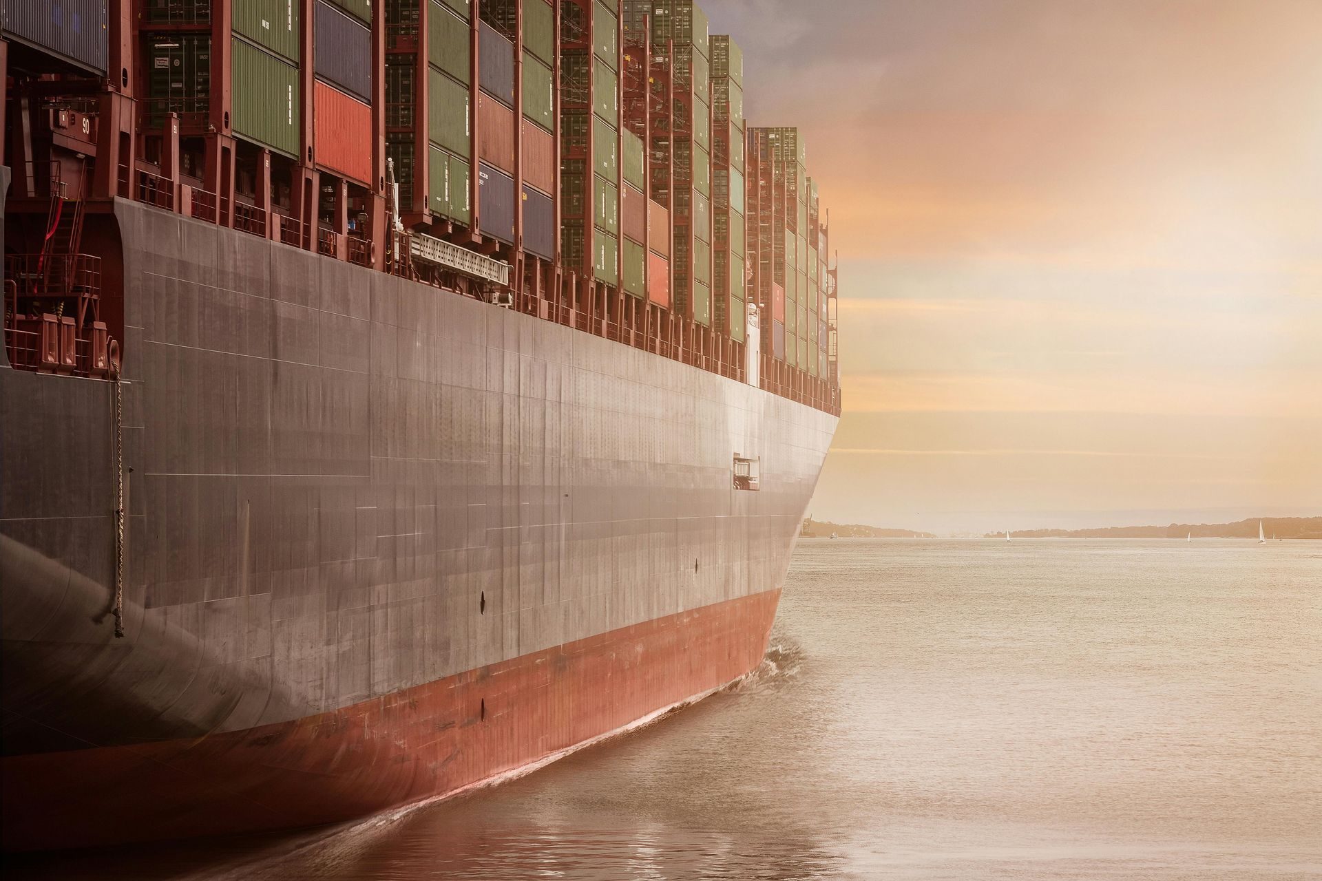 A large container ship is floating on top of a body of water.