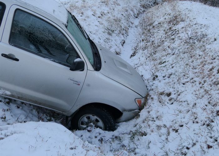 A truck stuck in a snowy ditch in red deer