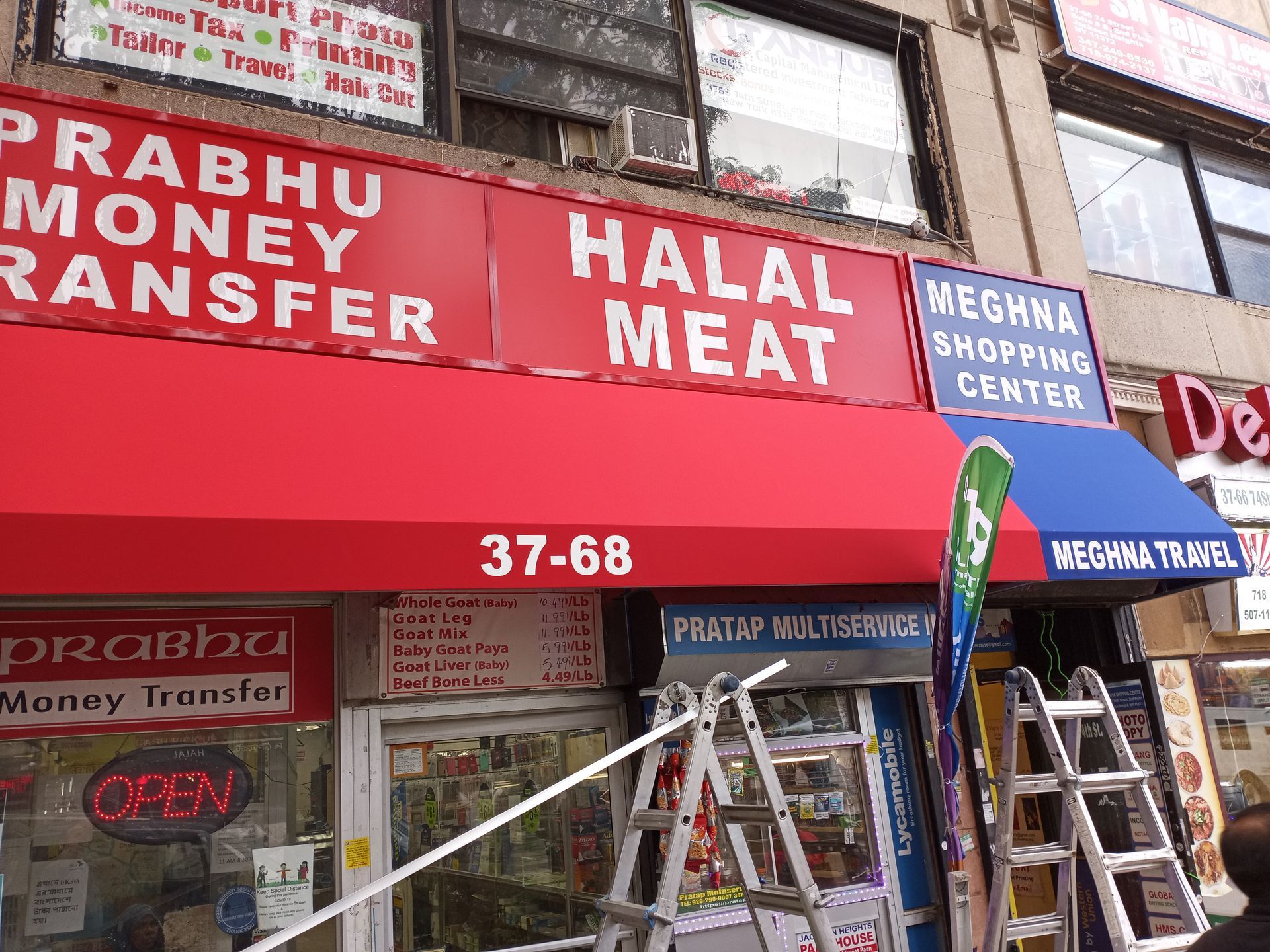 A store front with a red awning that says halal meat