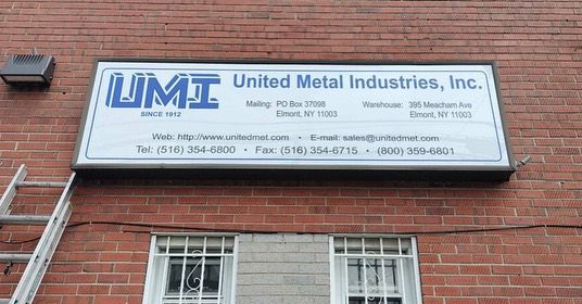 A united metal industries inc. lightbox sign on a brick building